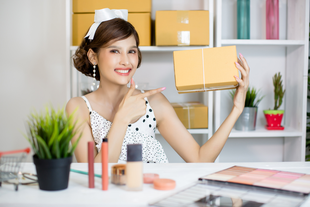 Asian girl working at home office and sorting parcel post box