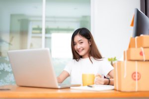 woman smiling in front of computer