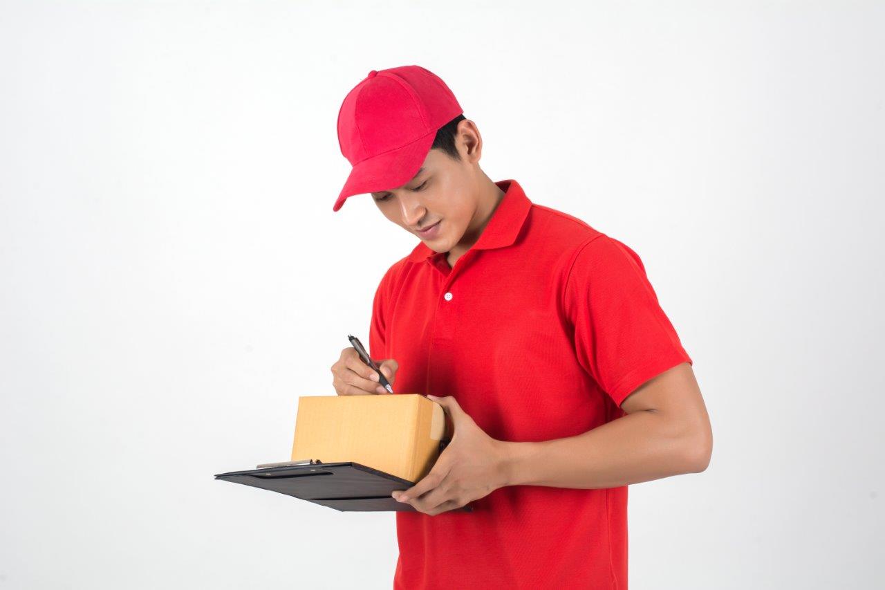 man in red shirt signing package