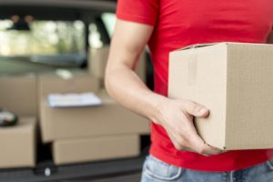 Close up of a delivery man holding a package