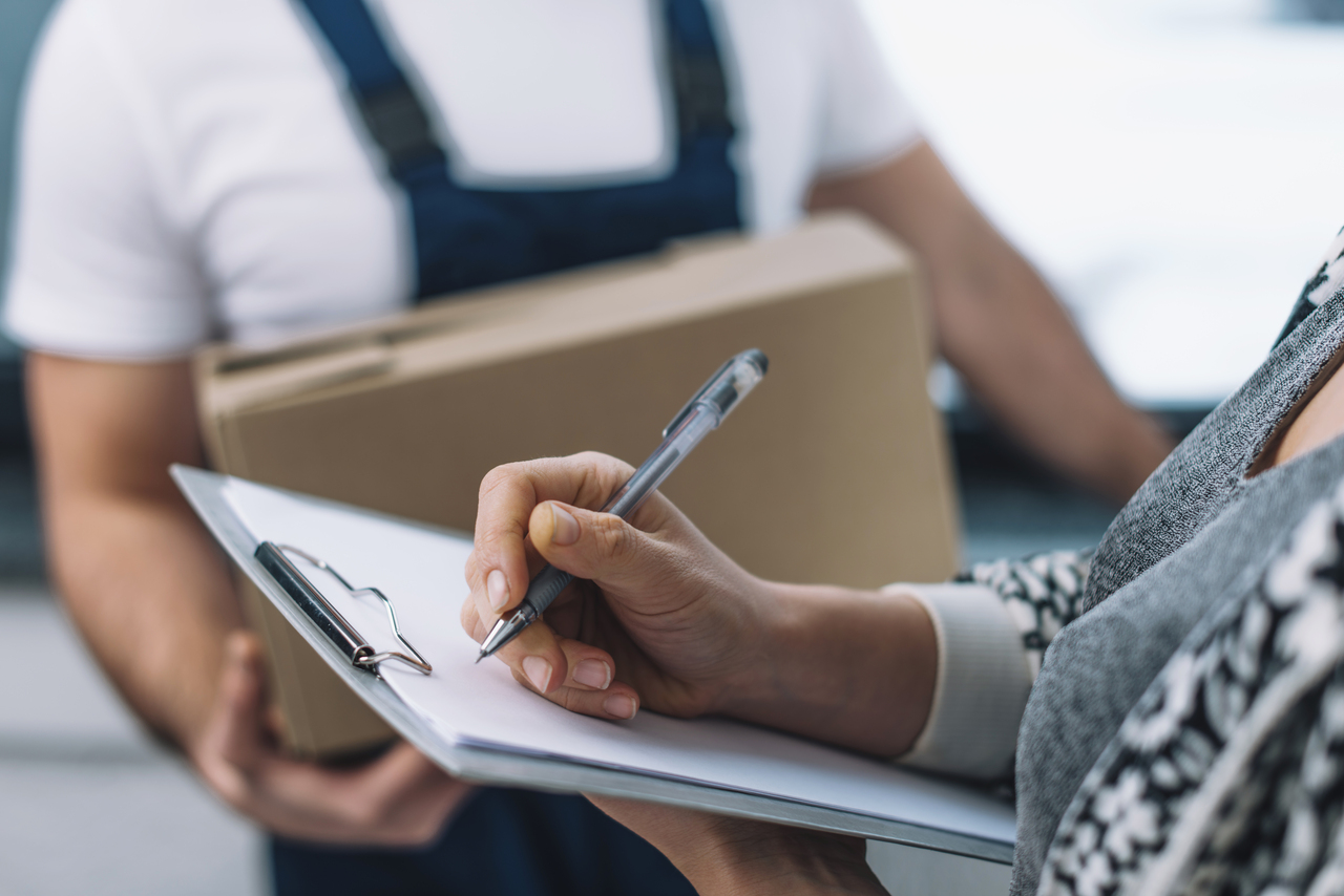 A woman signing an order fulfillment form